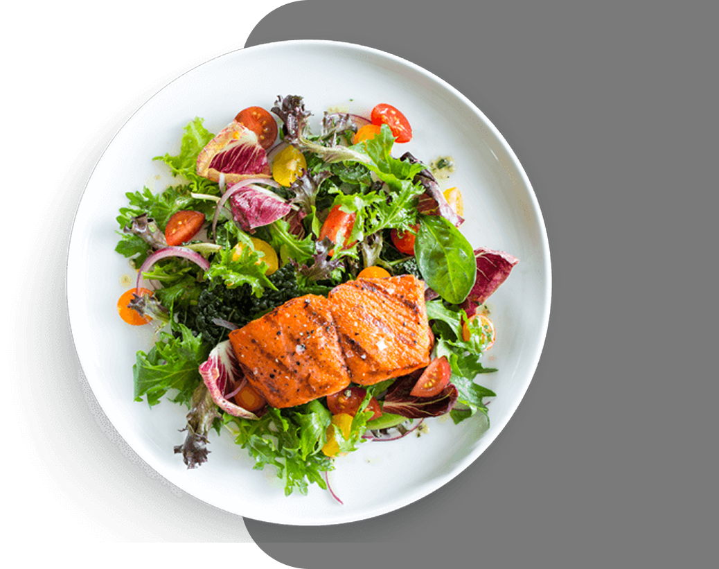 Grilled salmon with fresh salad on a white plate